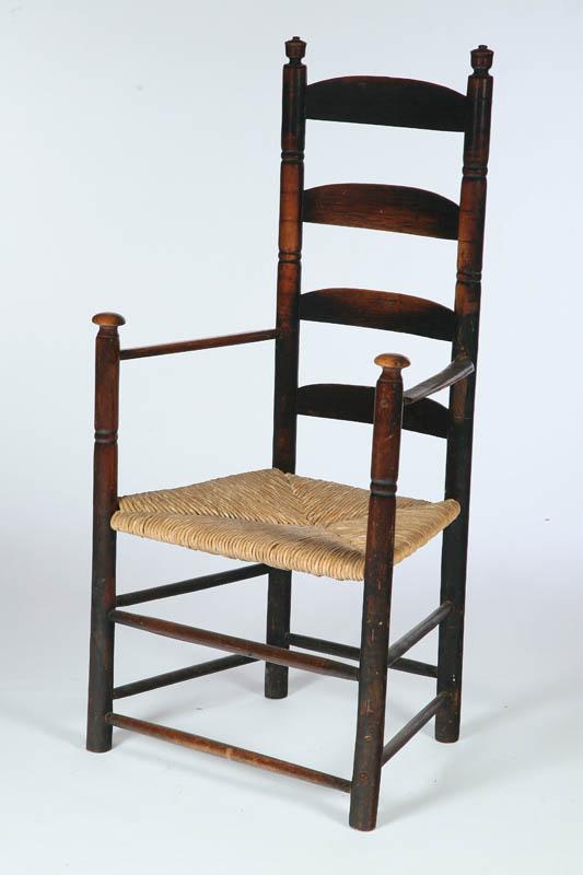 Appraisal: LADDERBACK ARMCHAIR American late th century mixed woods Sausage turnings