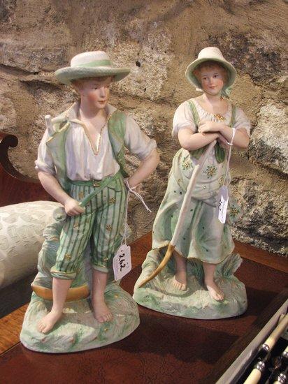 Appraisal: A PAIR OF CONTINENTAL BISQUE FIGURES modelled as a girl