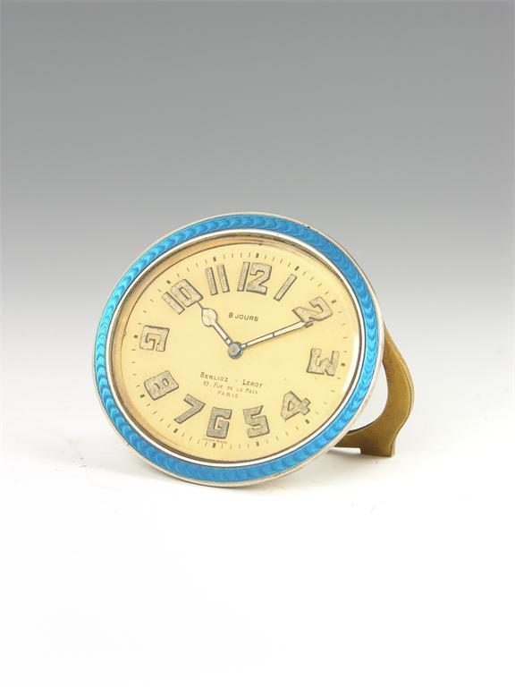 Appraisal: An enamel and brass oval strut timepiece