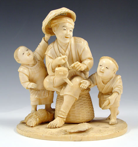 Appraisal: SIGNED CARVED IVORY FIGURAL GROUP Man with pipe enjoying the