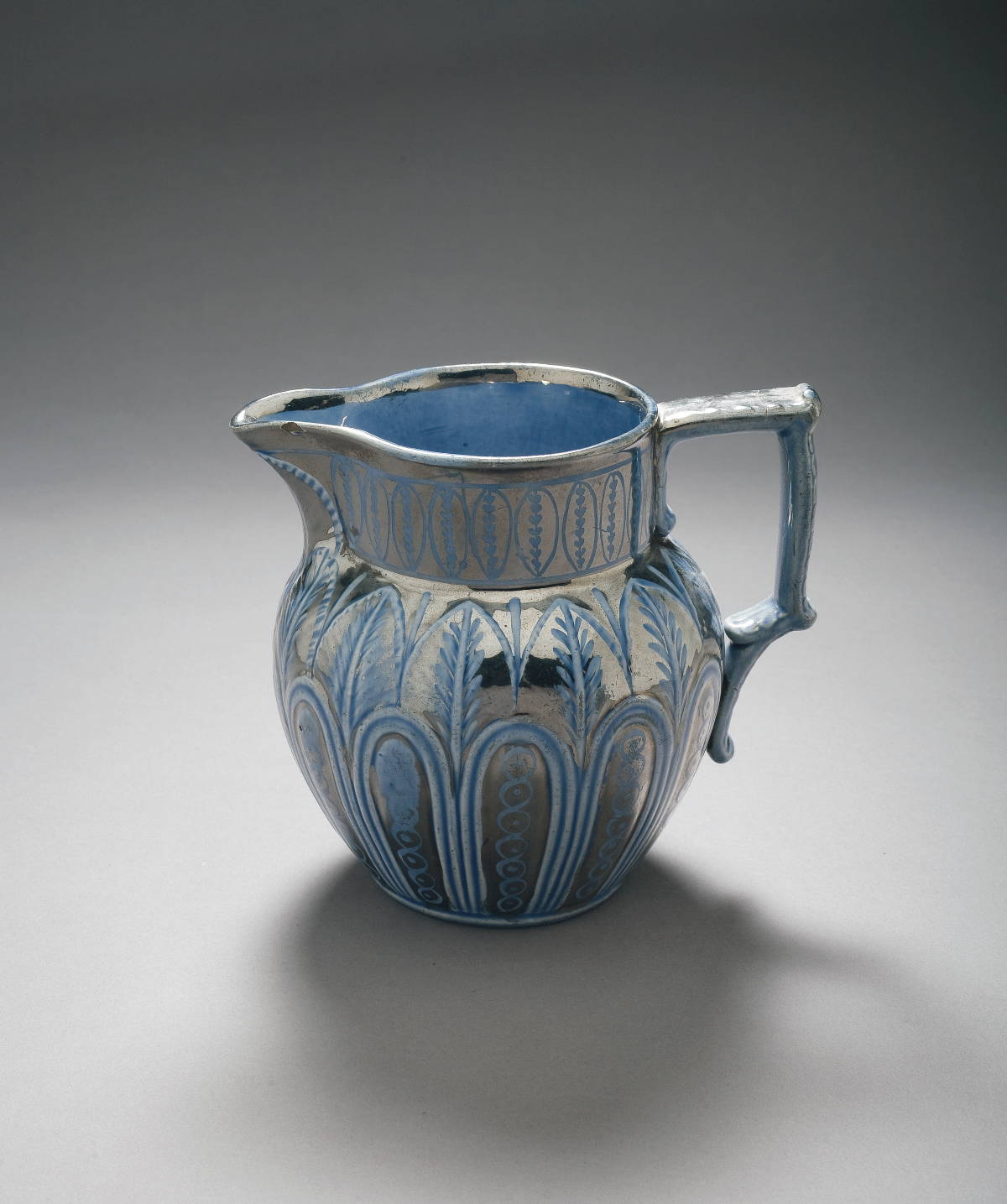 Appraisal: STAFFORDSHIRE BLUE-GLAZED SILVER RESIST LUSTRE JUG CIRCA - The medium