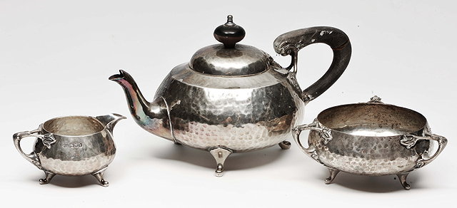 Appraisal: AN EDWARDIAN ARTS AND CRAFTS SILVER THREE PIECE TEA SET