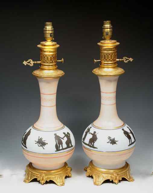 Appraisal: A PAIR OF TH CENTURY FRENCH BACCARAT OPALINE GLASS MODERATOR