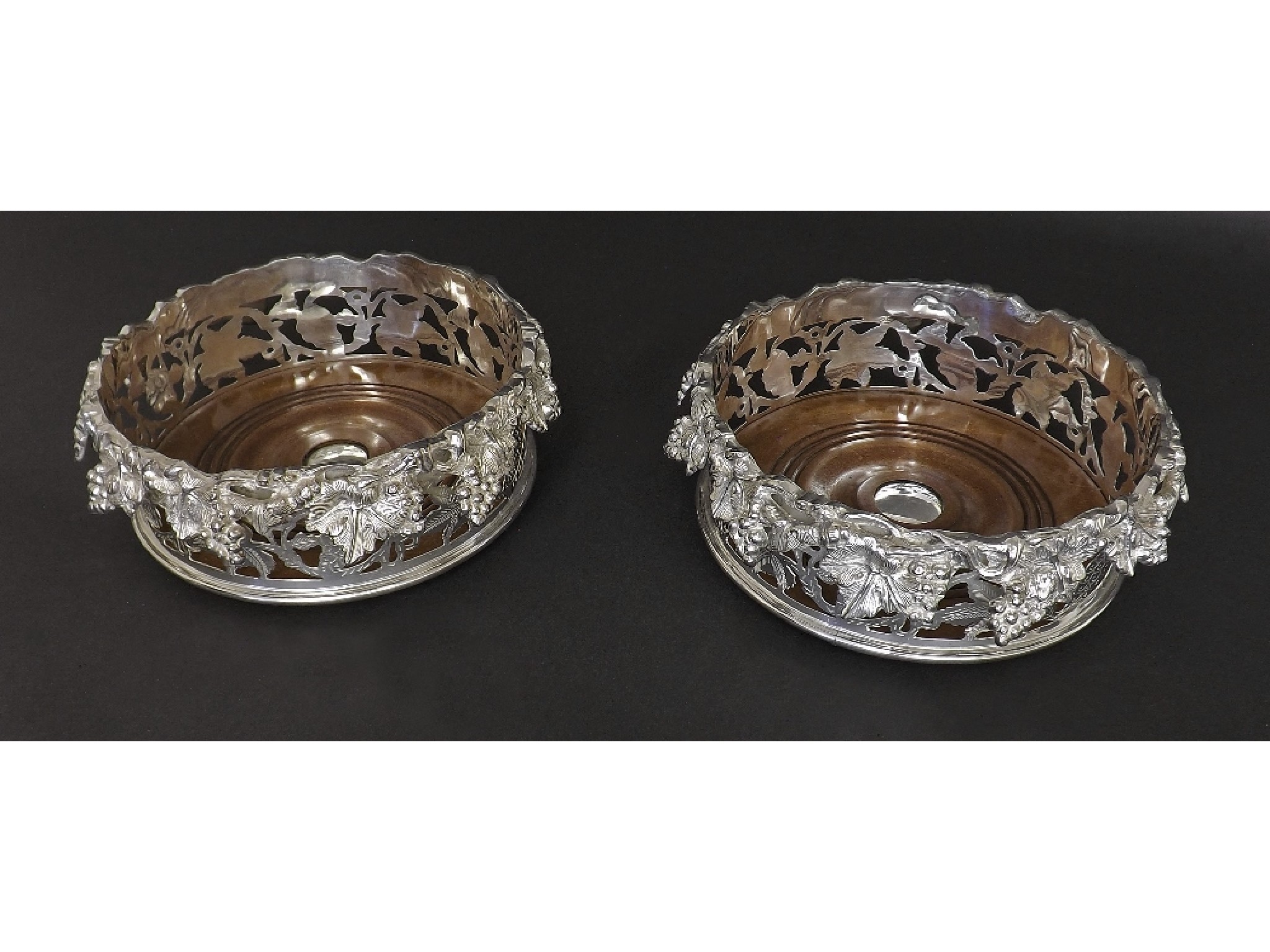 Appraisal: Pair of silver plated and turned hardwood wine coasters cast