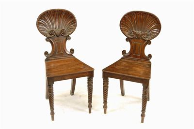 Appraisal: A pair of late Regency mahogany hall chairs in the