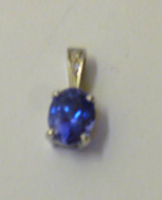 Appraisal: A TANZANITE PENDANT the oval cut tanzanite claw set in