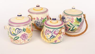 Appraisal: Poole Pottery four floral biscuit barrels three with raffia handles