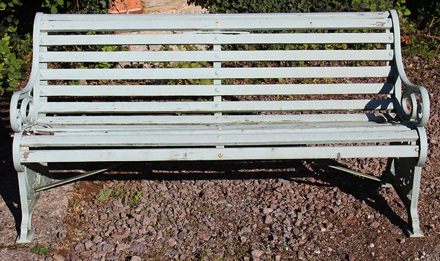 Appraisal: A PALE GREEN PAINTED GARDEN BENCH with cast iron ends