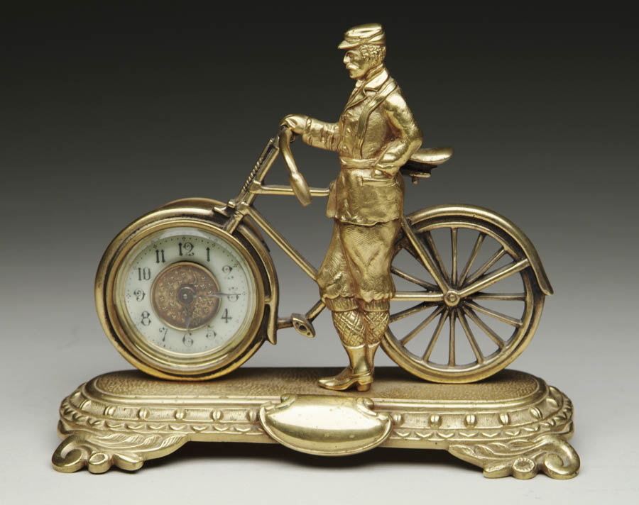 Appraisal: SAFETY CYCLIST CLOCK Clock is cast brass and depicts a