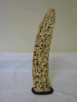 Appraisal: A CHINESE CARVED IVORY TUSK depicting many figures climbing a