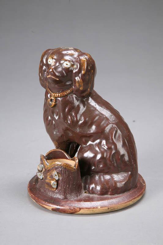 Appraisal: MATCH HOLDER White clay seated Spaniel with a tree trunk