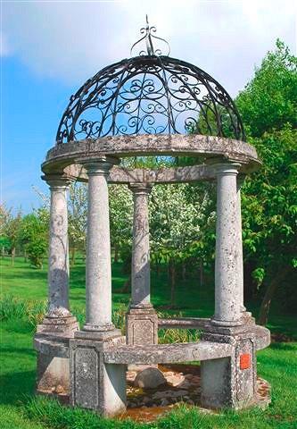 Appraisal: A composite stone rotunda with wrought iron cupola supported on