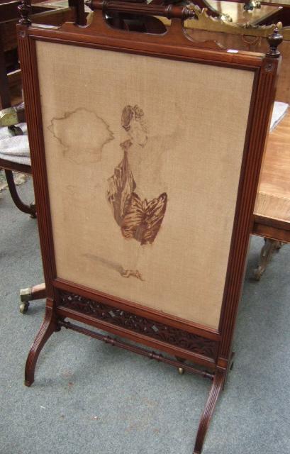 Appraisal: A Victorian mahogany framed fire screen with fluted handle and