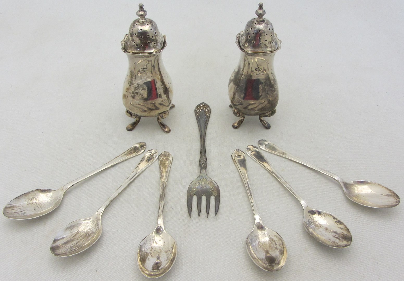 Appraisal: Silver comprising a pair of pepperettes each raised on four