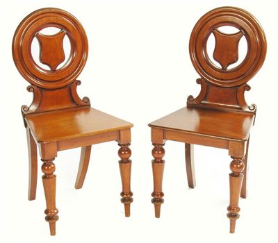 Appraisal: A pair of Victorian mahogany hall chairs the circular backs