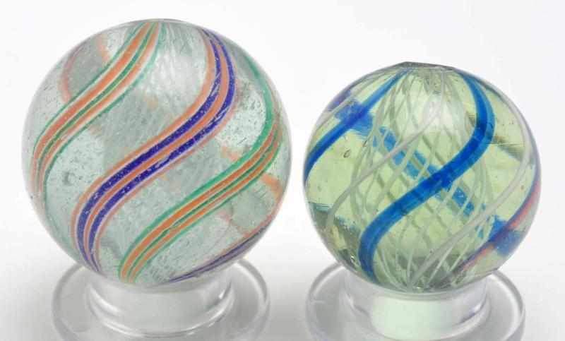 Appraisal: Lot of Latticino Swirl Marbles Description The smaller marble is