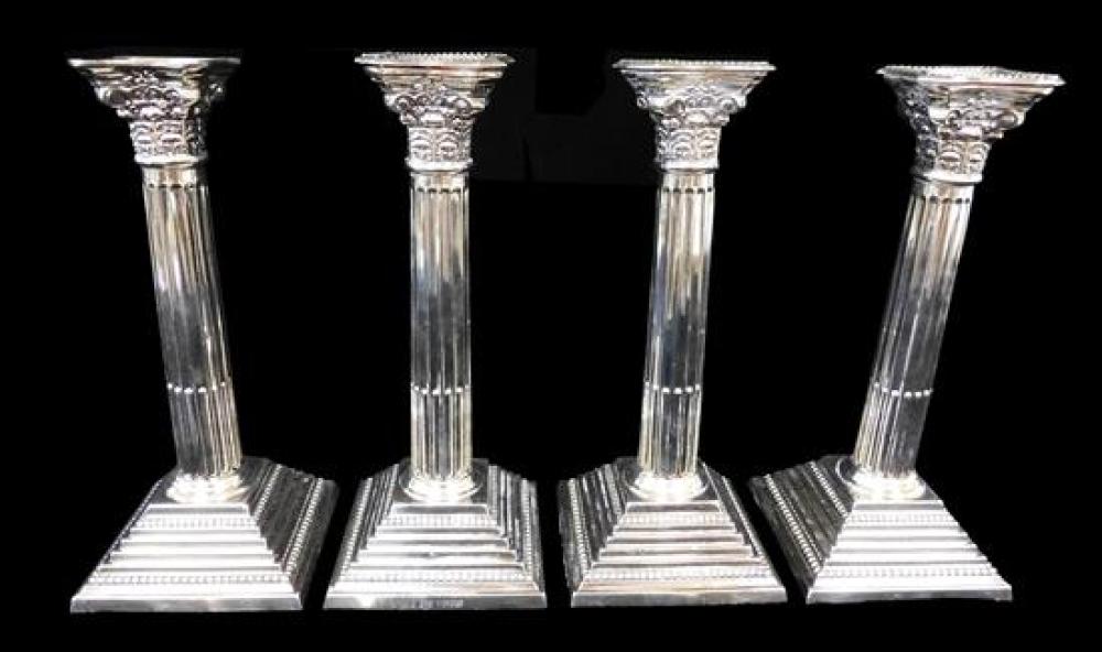 Appraisal: STERLING Set of four candlesticks London date mark Corinthian-style capital