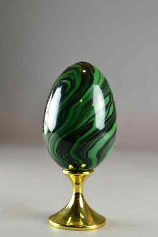 Appraisal: GREEN GLASS EGG ON BRASS STANDA green and black swirls