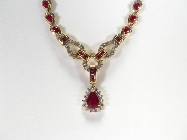 Appraisal: Lady's k yellow gold ruby and diamond pendant style necklace