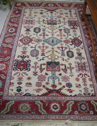 Appraisal: HAND KNOTTED ORIENTAL CARPET Indo-Persian tribal stylized floral and geometric