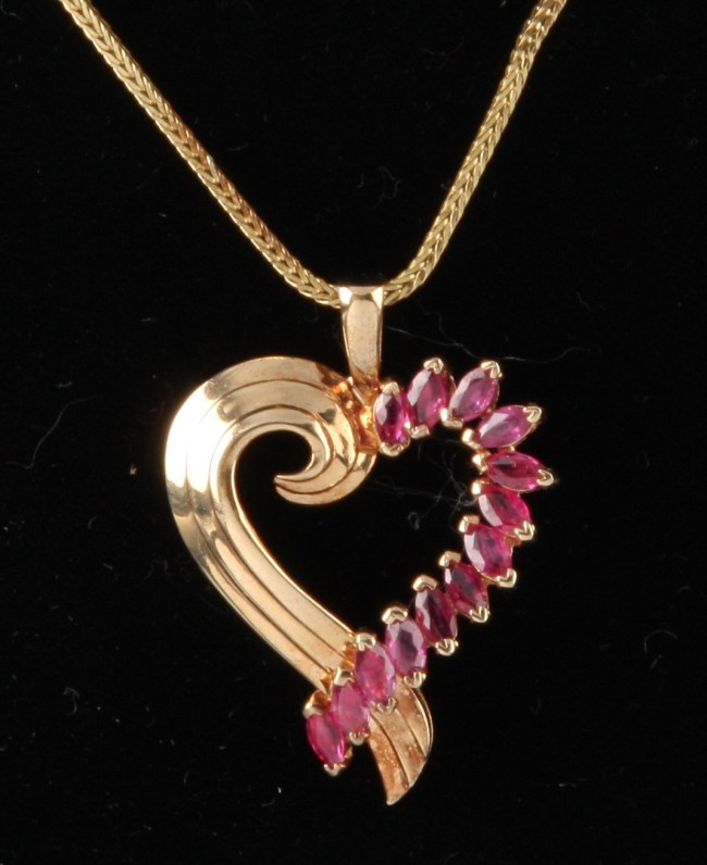 Appraisal: KY and ruby heart pendant with rubies K chain S