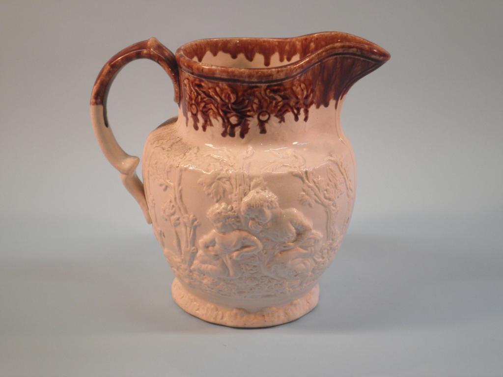 Appraisal: A thC Staffordshire stoneware jug decorated in relief with figures