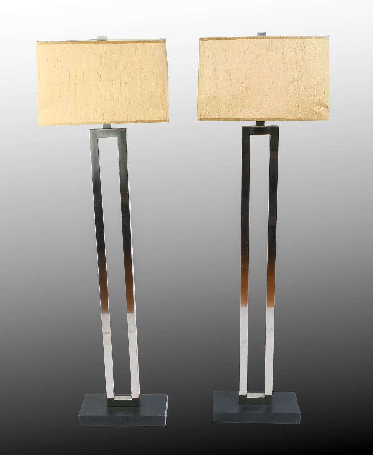 Appraisal: PAIR OF MODERN FLOOR LAMPS Chromed rectangular single light lamps