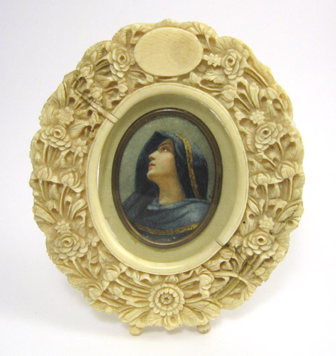 Appraisal: CARVED IVORY FRAME WITH PORTRAIT MINIATURE the th Century oval