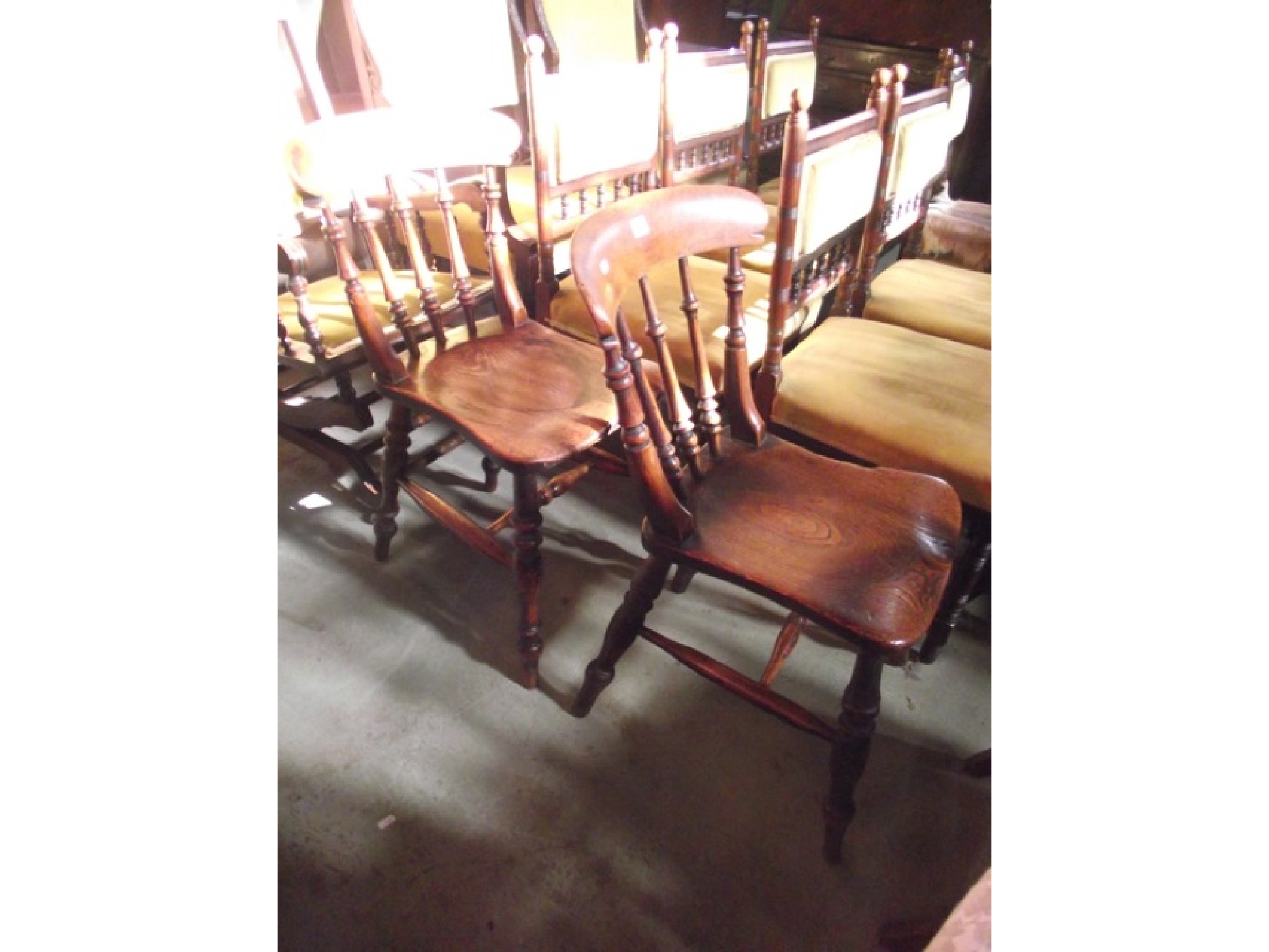 Appraisal: A pair of Victorian elm and ash kitchen chairs with