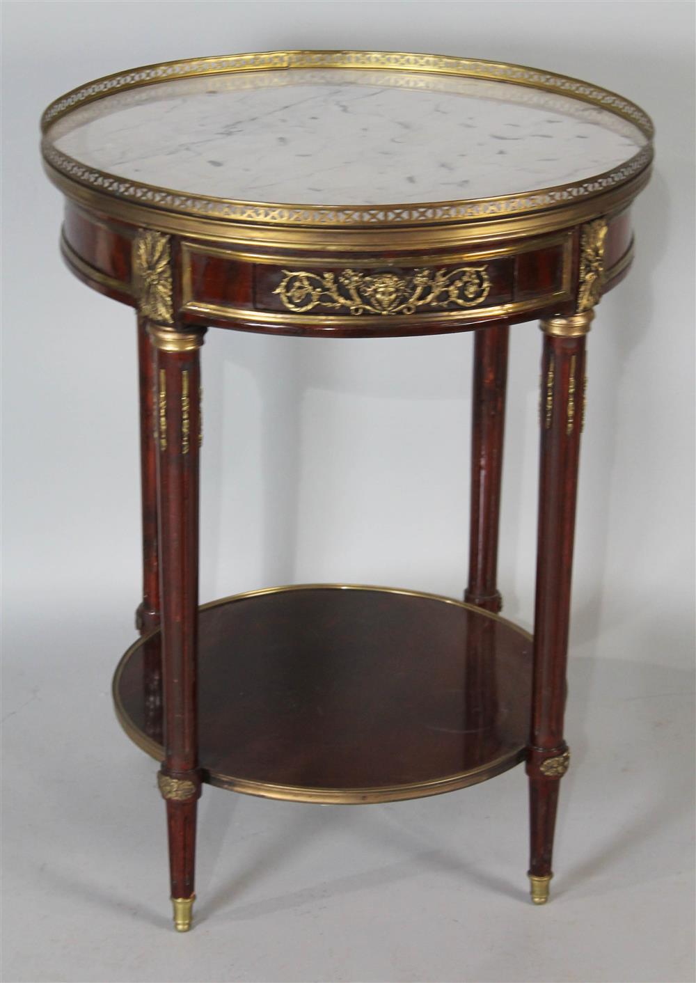 Appraisal: LOUIS XVI STYLE MARBLE TOP MAHOGANY ROUND TABLE pierced brass