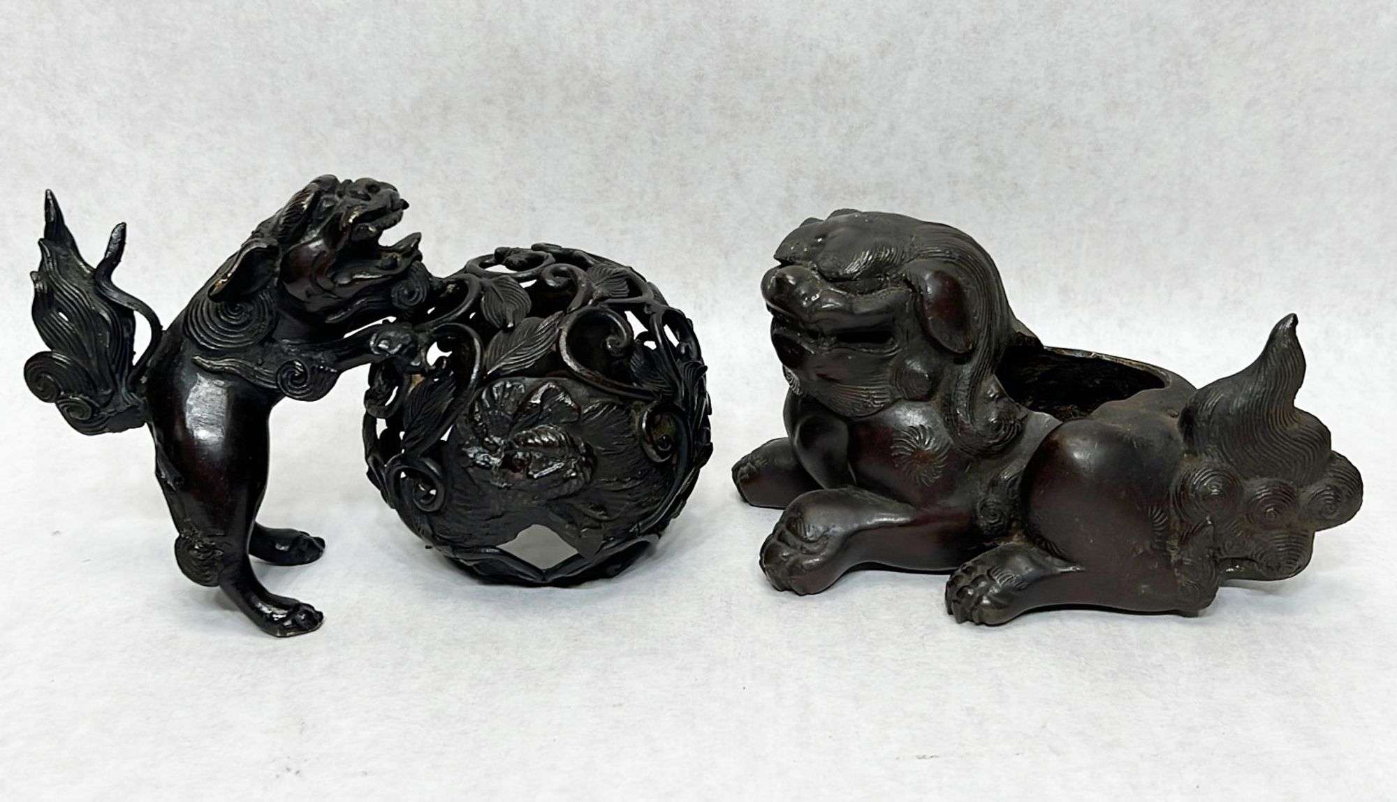 Appraisal: Asian bronze foo dogsIncludes censer figure Foo dog w ball