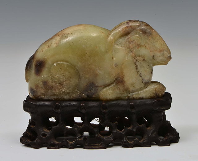 Appraisal: A CHINESE MOTTLED GREEN GREY AND BLACK JADE PEBBLE carved