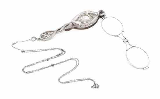 Appraisal: A Silvered Metal Lorgnette the body having intertwined serpent decoration