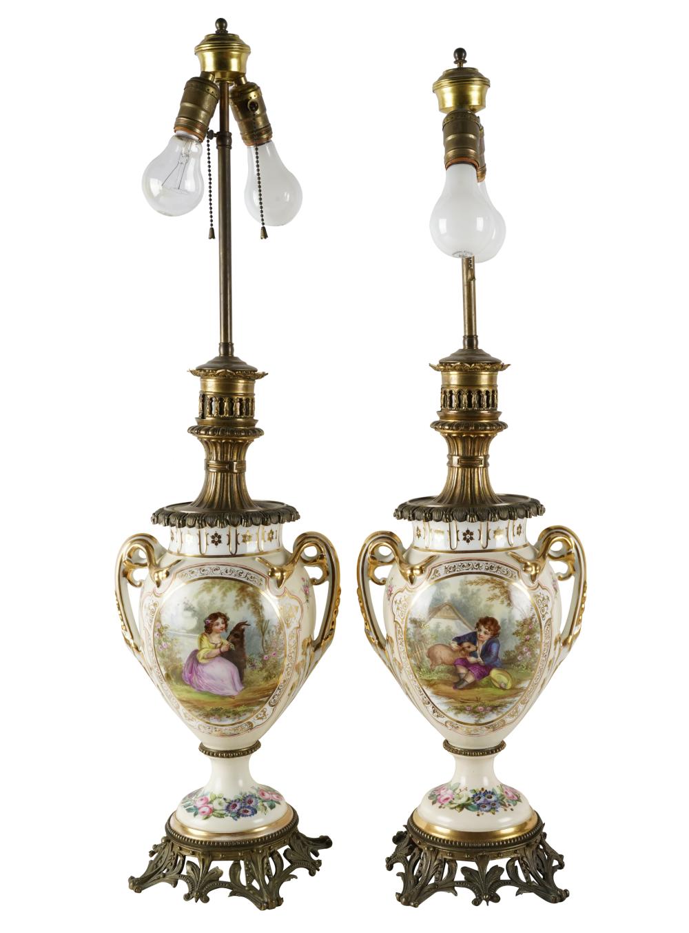 Appraisal: PAIR OF CONTINENTAL PORCELAIN URNShand-painted with gilt metal mounts electrified