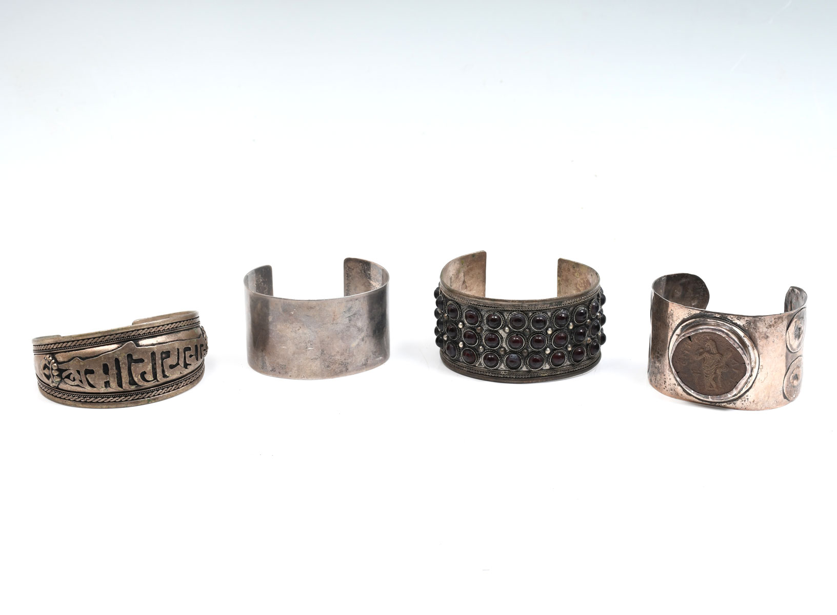 Appraisal: SILVER CUFF BRACELETS Tibetan mantra cuff measures '' inside with