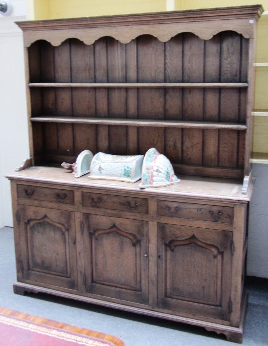 Appraisal: An th century style oak dresser the enclosed two tier