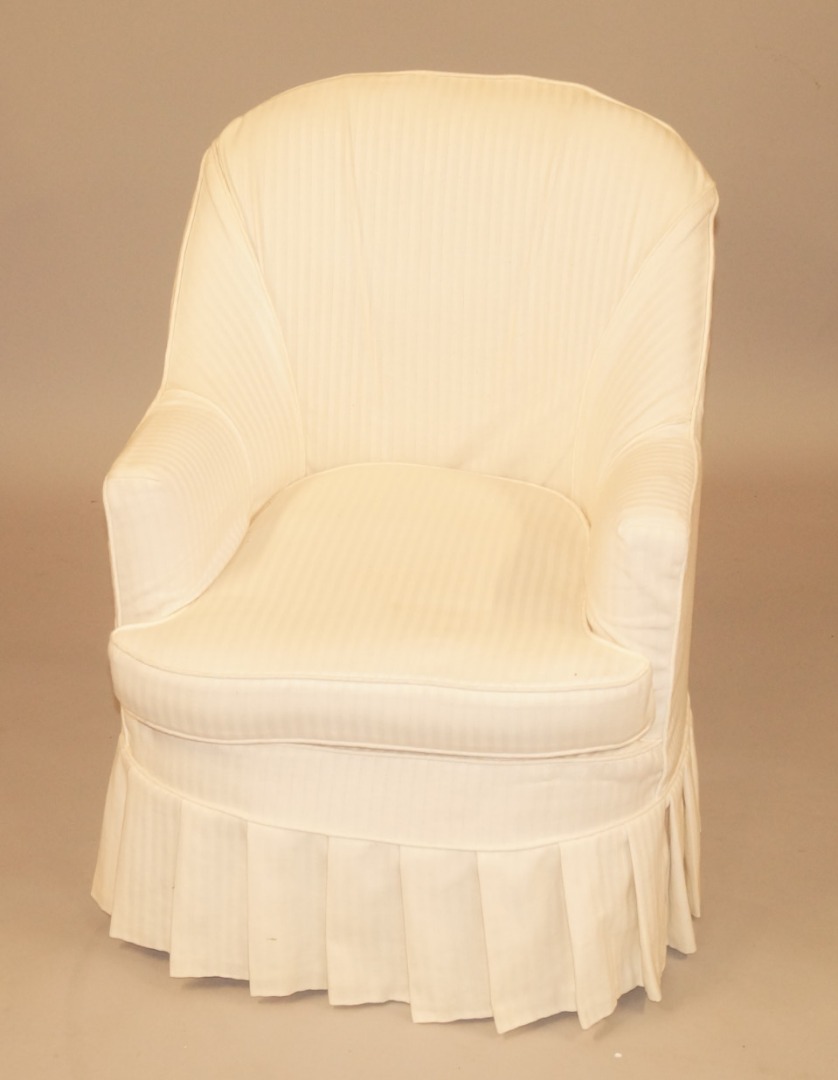 Appraisal: An early thC tub shaped armchair with modern cream striped