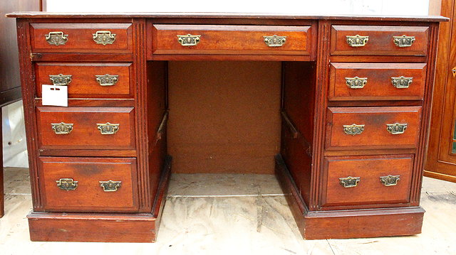 Appraisal: A TH CENTURY REPRODUCTION MAHOGANY DESK with nine drawers cm