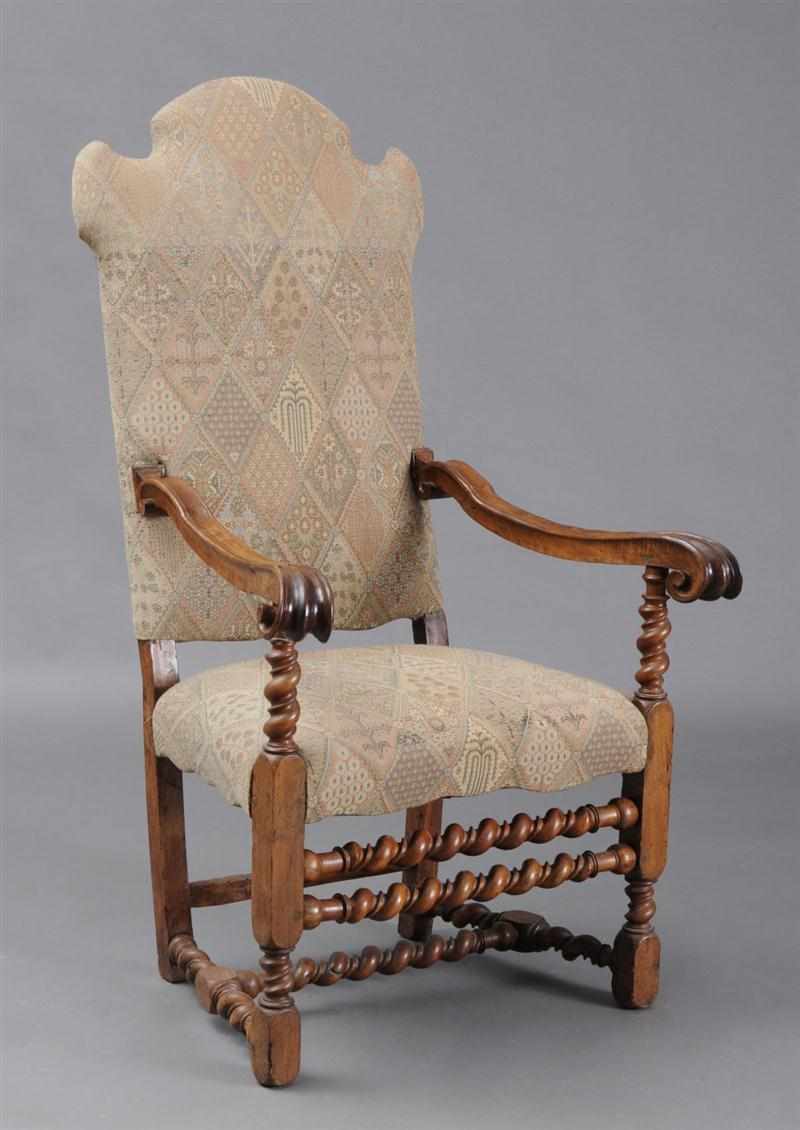 Appraisal: ITALIAN BAROQUE CARVED WALNUT ARMCHAIR With shaped padded back and