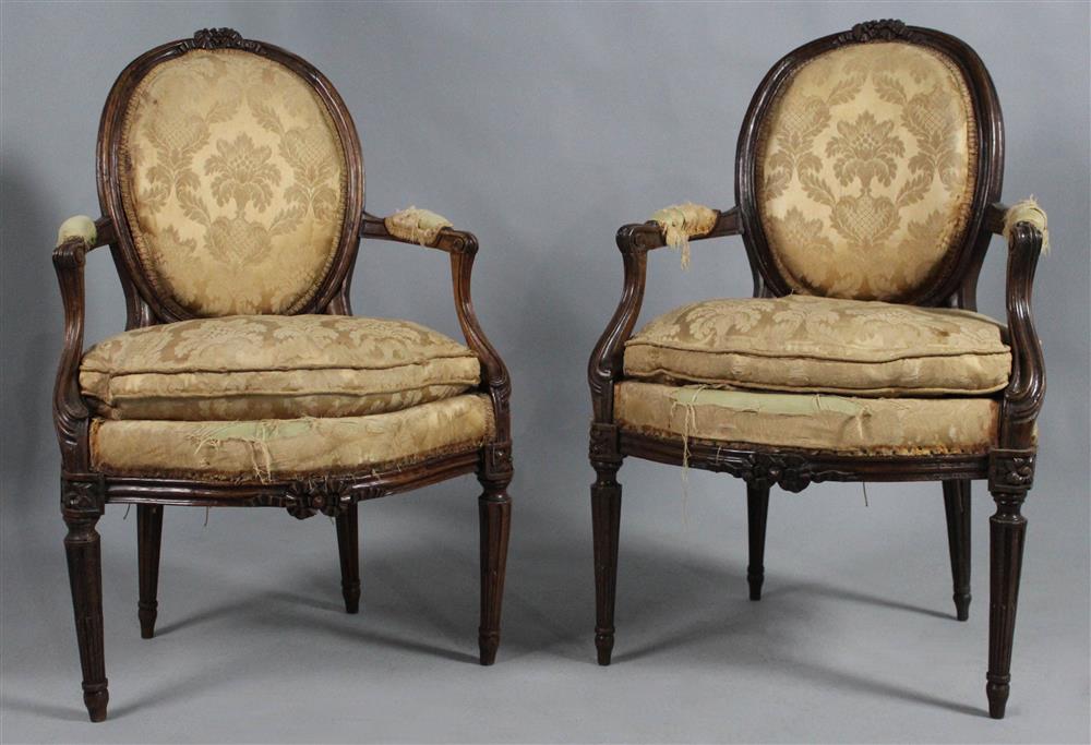 Appraisal: PAIR OF LOUIS XVI WALNUT FAUTEUILS circa cafe au lait