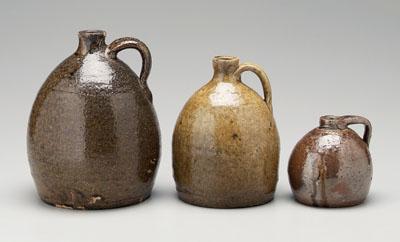 Appraisal: Three Georgia stoneware jugs one with bulbous body runny brown