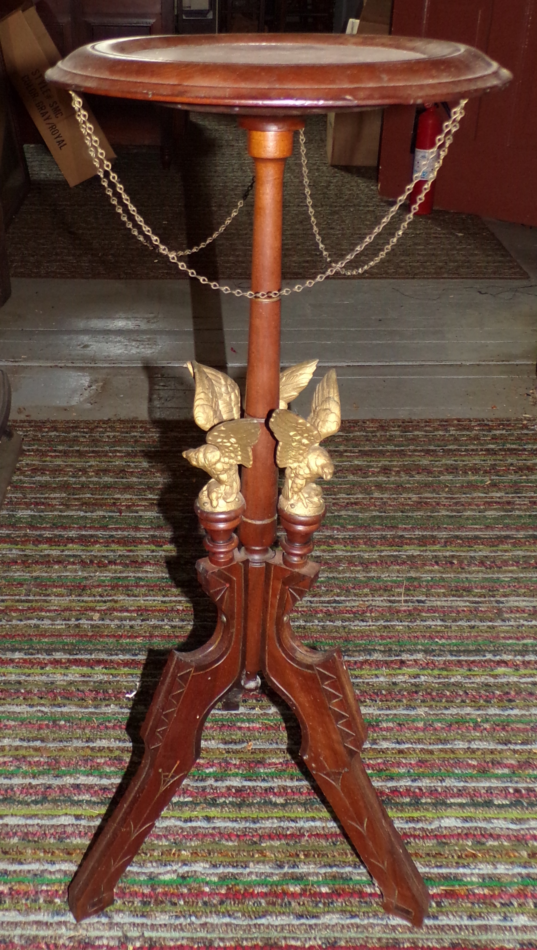 Appraisal: Walnut plant stand adorned with eagles ''