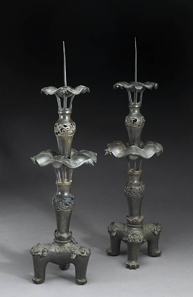 Appraisal: A pair of tall bronze candle prickets Qing Dynasty Each