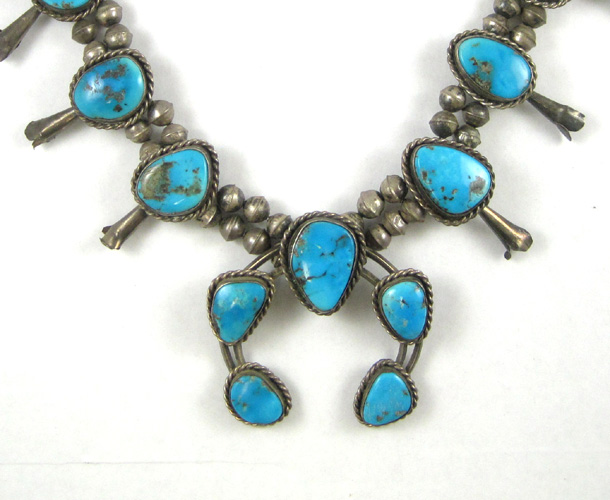 Appraisal: NAVAJO TURQUOISE AND SILVER SQUASH BLOSSOM NECKLACE having single-stone squash