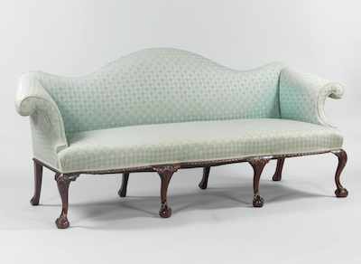 Appraisal: A Chippendale Style Camelback Sofa Traditional camelback sofa with mahogany