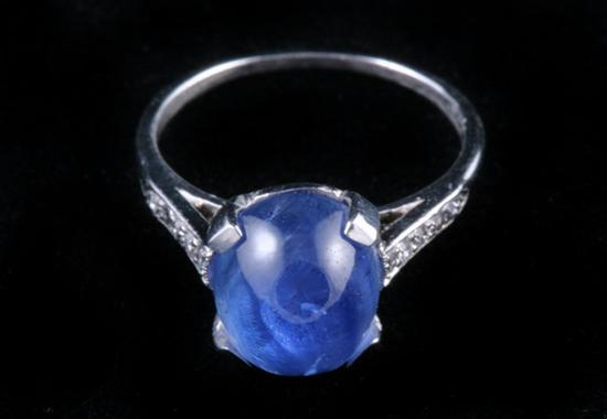 Appraisal: ART DECO PLATINUM DIAMOND AND SAPPHIRE RING Oval sapphire cabochon