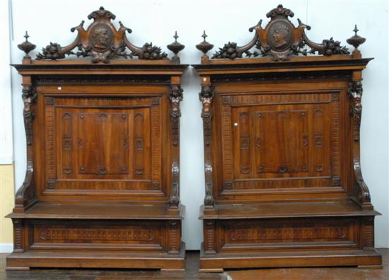 Appraisal: PAIR OF HEAVILY CARVED HALL BENCHES With putti carving center