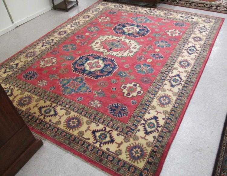 Appraisal: HAND KNOTTED ORIENTAL CARPET Pakistani Caucasian three geometric medallions and