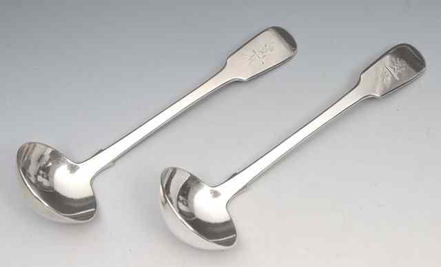 Appraisal: A PAIR OF VICTORIAN IRISH SILVER FIDDLE PATTERN SAUCE LADLES