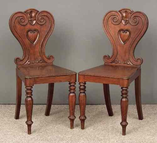 Appraisal: A pair of William IV mahogany hall chairs with shaped